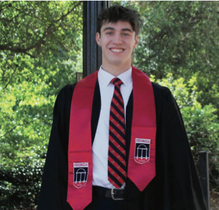 Picture of German program alum Nathan Howrey in front of the UGA arch with trees in the background.