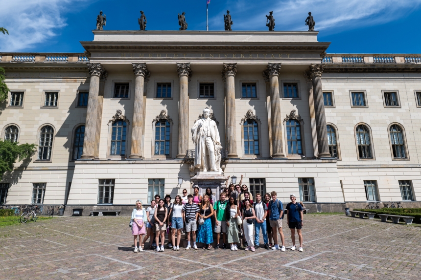 Group photo in front of statue