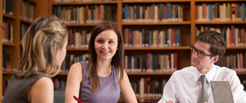 Environmental portrait of graduate Amazing Student Victoria Barker (2nd from left) working on a project with other second-year law students (L-R) Maria Kachniarz and Wheaton Webb in the Sohn International Law Library at ...